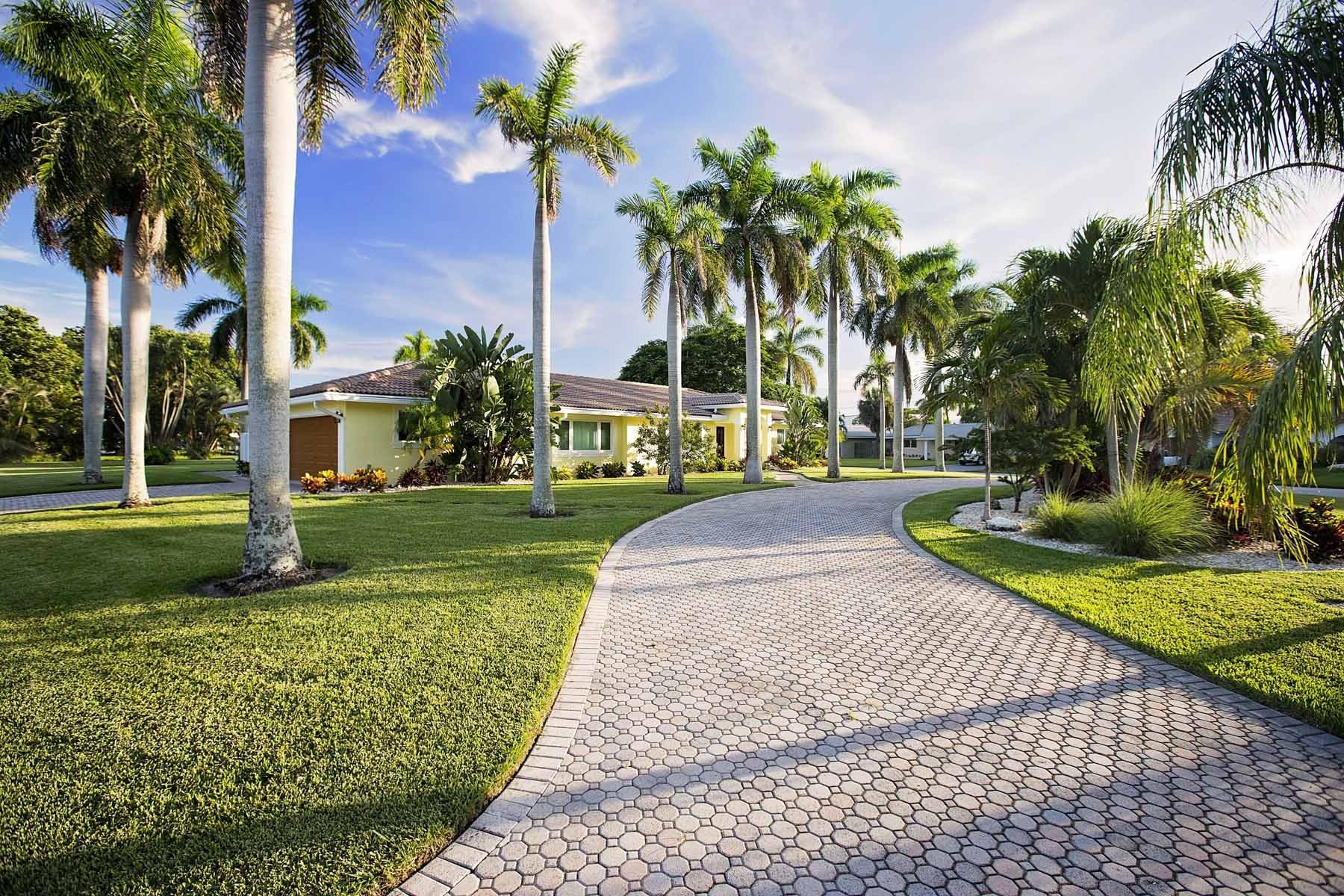 Backyard pool with pristine lawn care and patio in Delray Beach