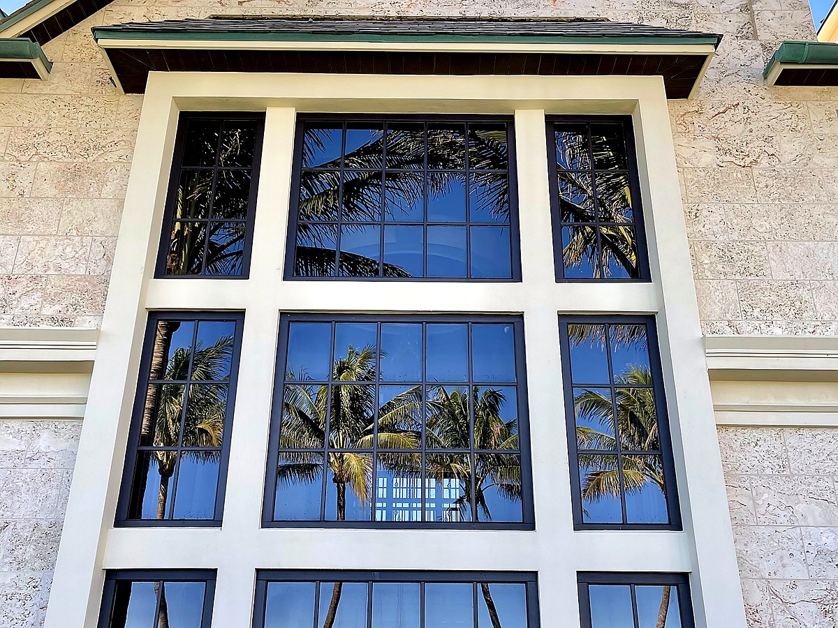 Beachfront estate with professionally cleaned windows reflecting coastal scenery