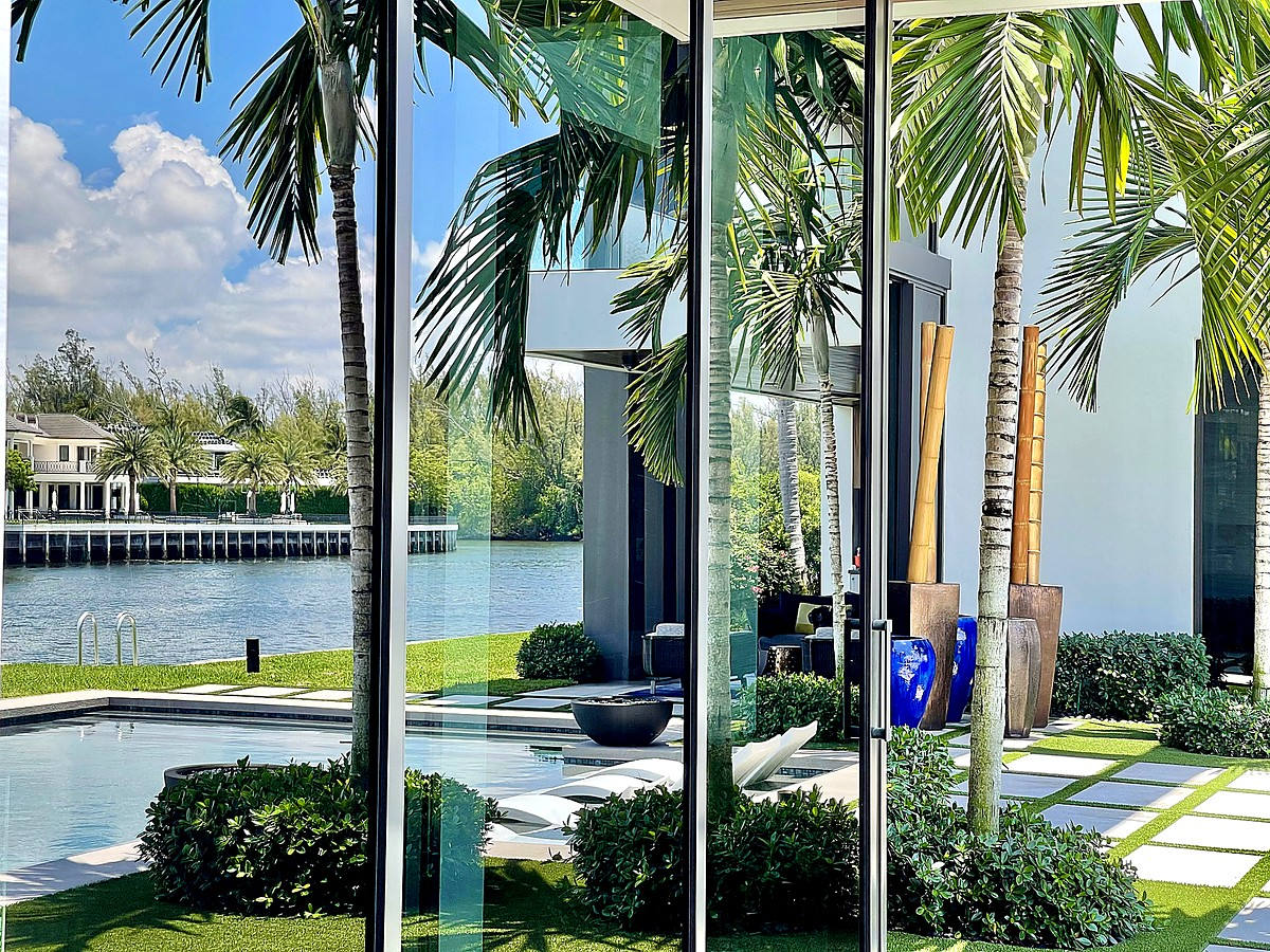 Beachfront estate with professionally cleaned windows reflecting coastal scenery