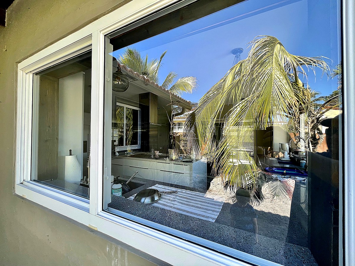 Deerfield Beach coastal home with clean sliding glass doors overlooking pool