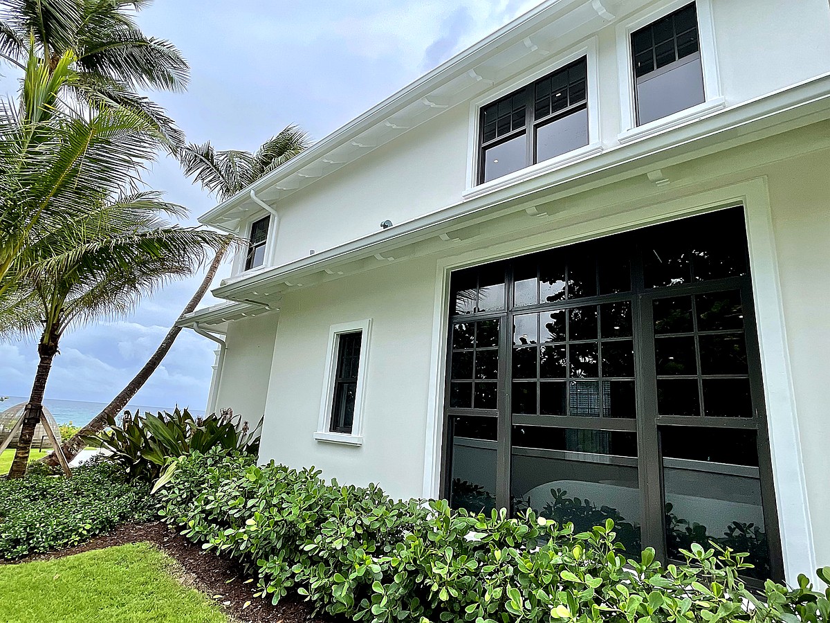 Coastal mansion with pristine clean windows and ocean palms in Pompano Beach FL