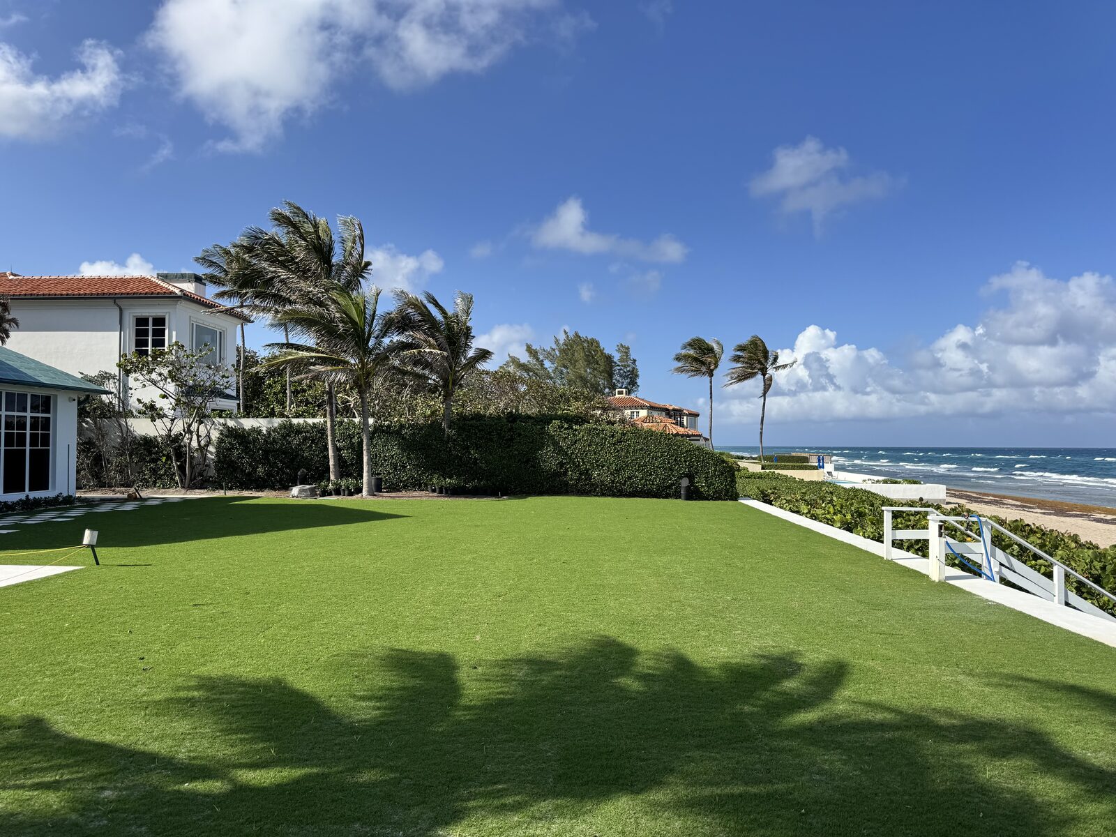 Completed sod installation with lush green lawn at a beachfront estate in South Florida