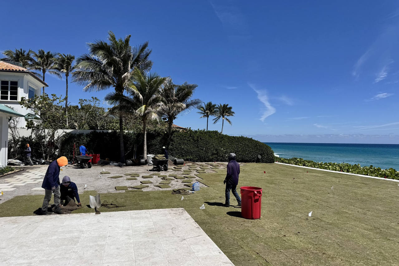 Crew finishing sod install at luxury estate