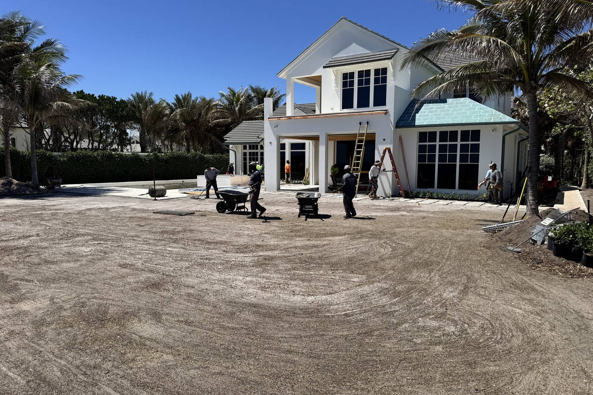Crew spreading soil for beachfront sod installation