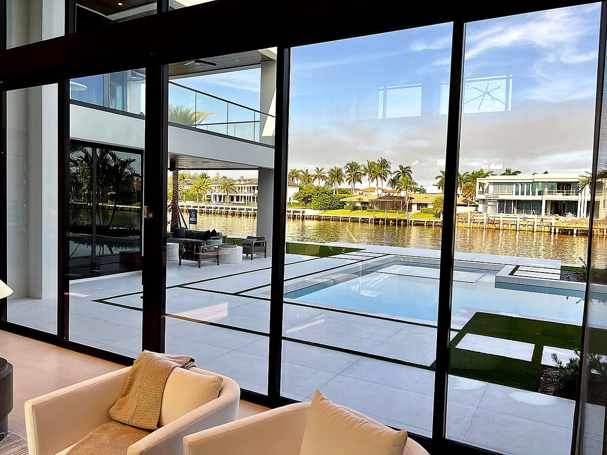 Interior panoramic view through pristine glass walls overlooking Intracoastal Waterway in Boca Raton