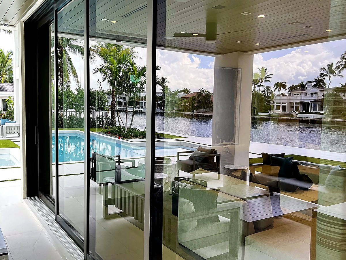 Intracoastal canal home with pristine sliding glass doors and pool near Lighthouse Point
