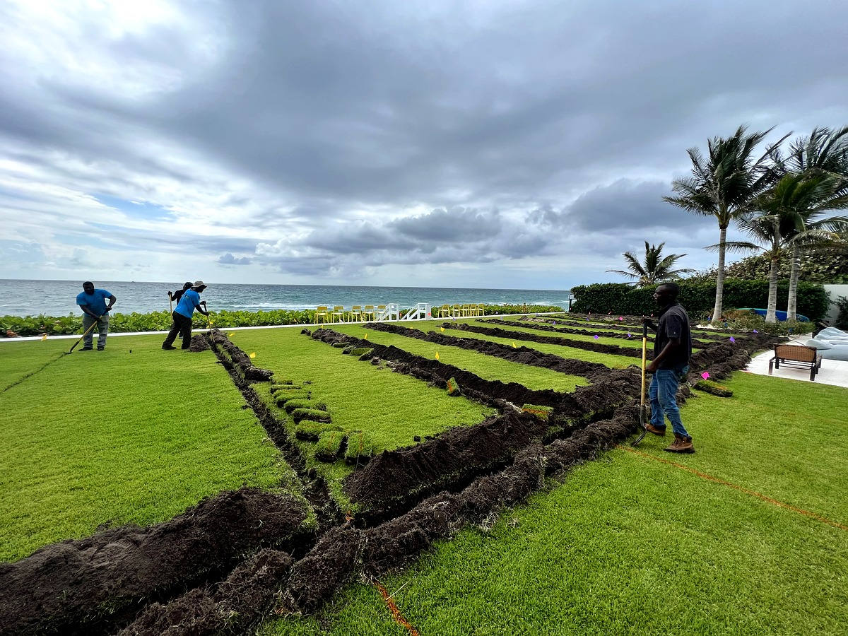 Irrigation system installation oceanfront property Delray Beach — crew installing sprinkler lines and sod on beachfront estate