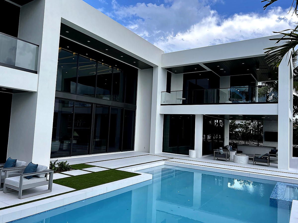 Modern luxury estate with crystal clear floor-to-ceiling windows and pool in Boca Raton FL