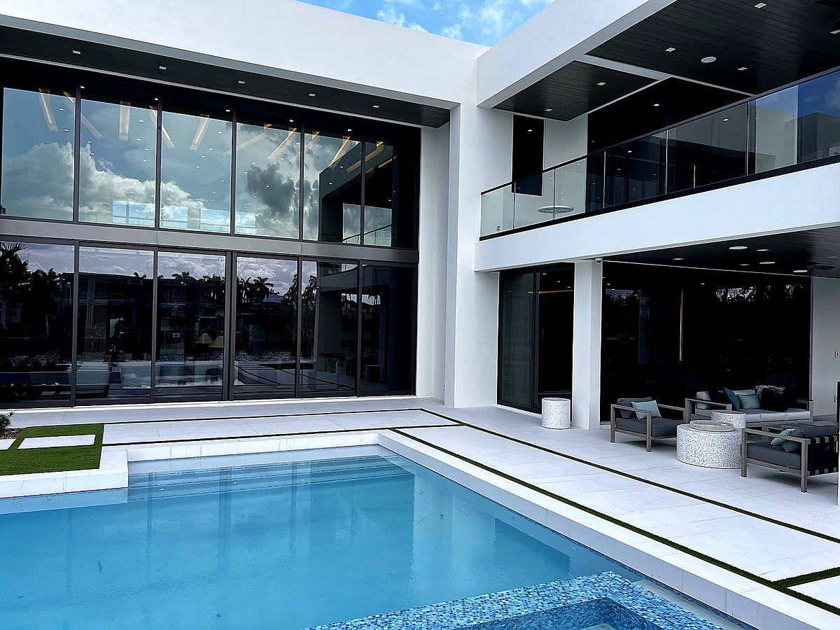 Modern waterfront home with crystal clear reflective glass near Deerfield Beach FL
