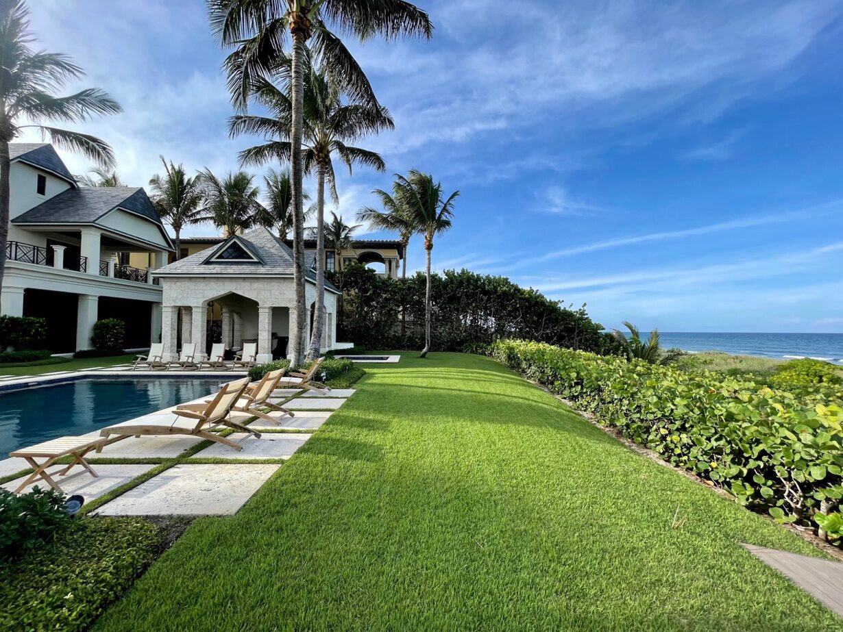 Oceanfront estate lawn, hedges and pool running to the ocean — coastal South Florida property care by Florida Boys Lawn & Landscape