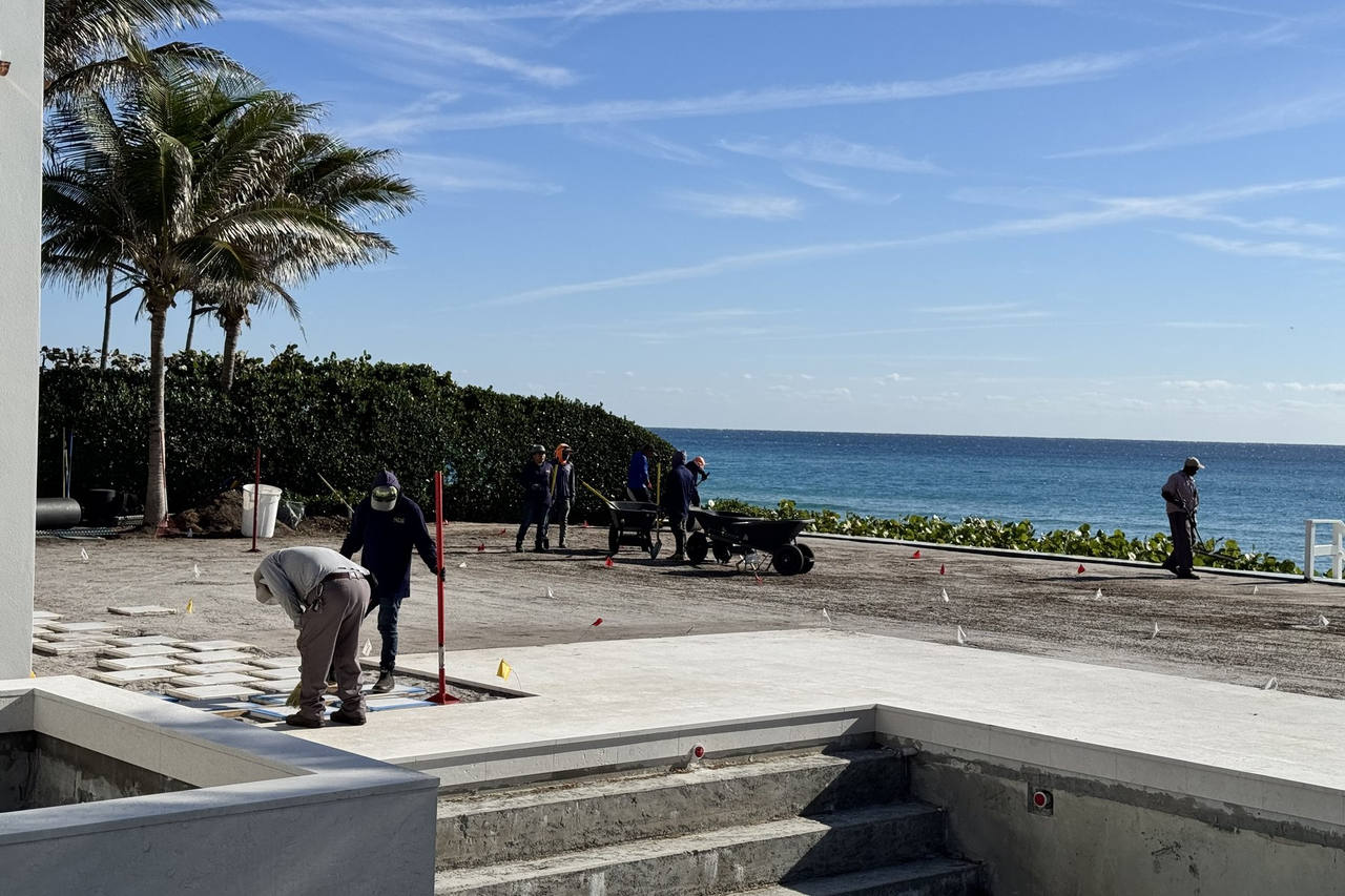 Oceanfront crew leveling ground for sod prep