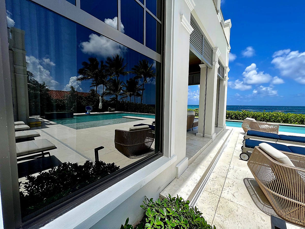 Oceanfront estate with crystal clear glass reflections of pool and ocean in Delray Beach FL