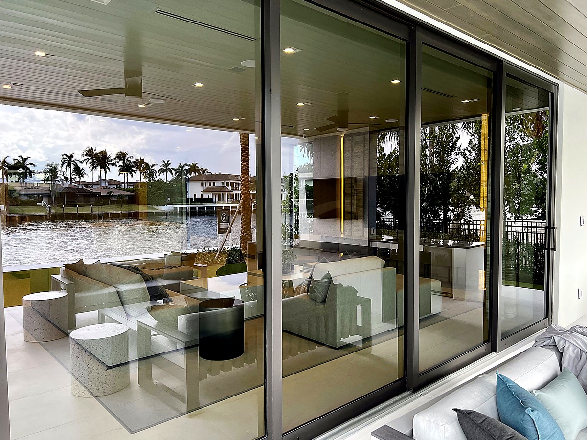 Pristine poolside sliding glass doors overlooking waterfront in Delray Beach