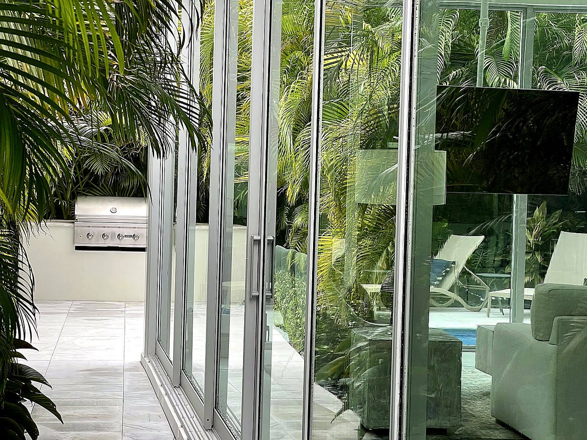 Tropical estate with pristine glass and lush landscaping in Deerfield Beach FL