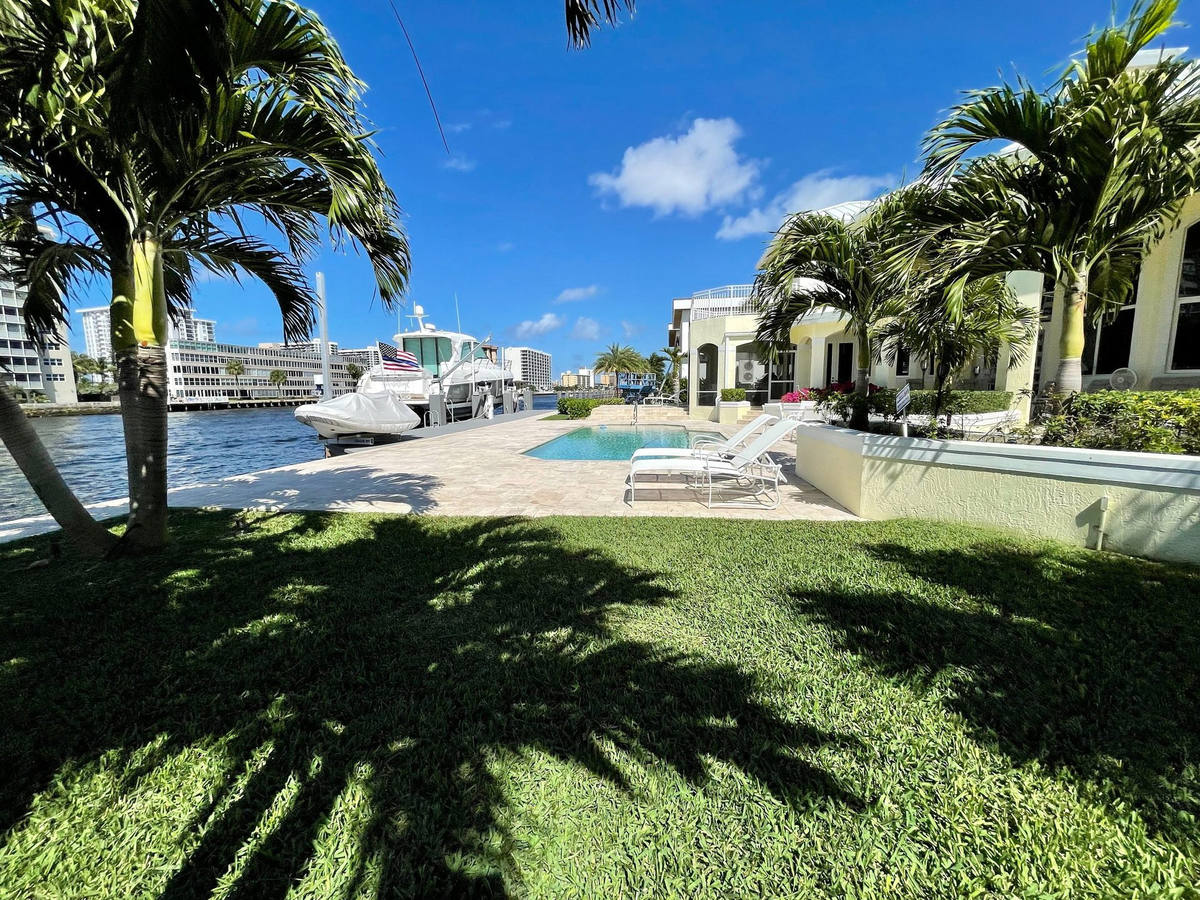 Waterfront pool, lawn and palms on the Intracoastal in Pompano Beach, cared for by Florida Boys Lawn & Landscape