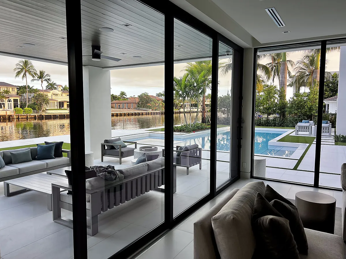 Clean floor-to-ceiling glass overlooking canal and pool in Boca Raton