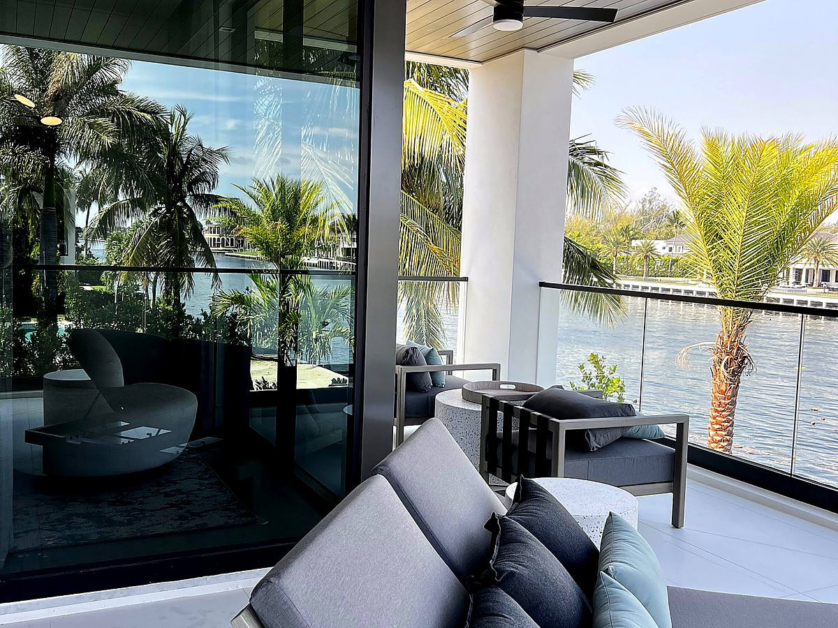 Waterfront balcony with pristine glass and palm views in Lighthouse Point FL