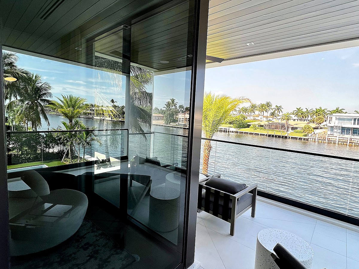 Coastal mansion with pristine clean windows and ocean palms in Pompano Beach FL