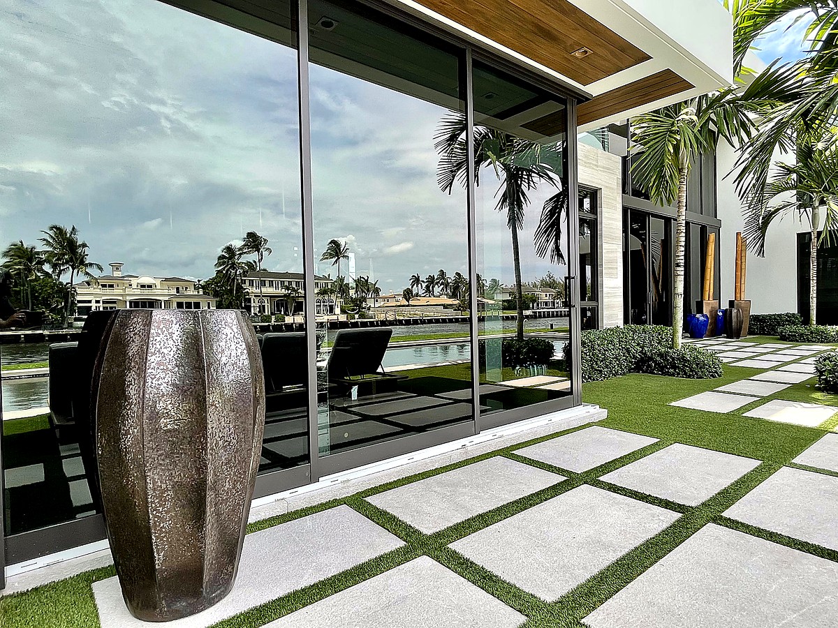 Modern waterfront home with crystal clear reflective glass near Deerfield Beach FL